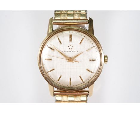 9ct gold Eterna-matic wrist watch having a textured silver dial with gilt baton markers to the chapter ring. Hallmarked Londo