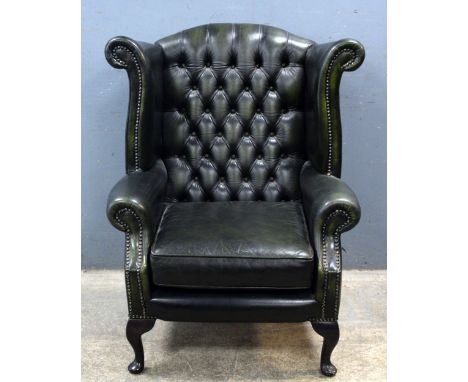 Green leather button back winged upholstered arm chair 