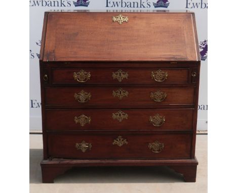 George III mahogany bureau, the fall flap enclosing central cupboard flanked by drawers and pigeon holes, over four long grad