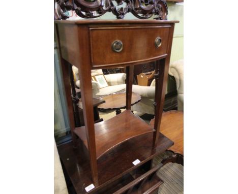 A mahogany finished bow front lamp table, fitted with a single drawer, with a shaped undertier