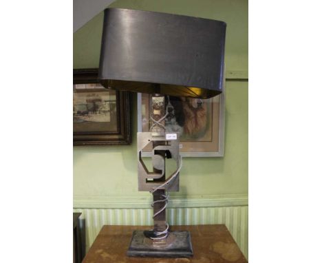 A late 20th-century design a table lamp, mixed metal column and stylised cut out slab, the whole supported on rectangular woo