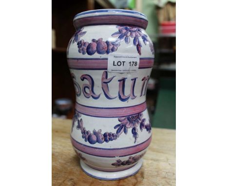 A 19th century French glazed terracotta albarello, pink &amp; blue painted decoration of flowers &amp; fruit swags amidst ban