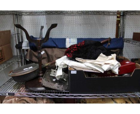 A shelf full of domestic items to include a Middle Eastern repousse tray