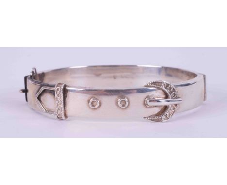 A silver hinged buckle design bangle, safety chain missing, 16.51g.