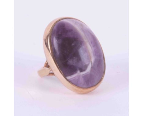 A 9ct yellow gold ring set with a large oval cabochon cut tumbled banded amethyst stone, approx., 2.8cm x 2cm, 9.72g, size M.