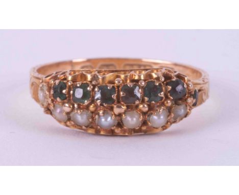 An antique 15ct yellow gold ring with an engraved patterned band and set with a row of seven seed pearls &amp; a row of seven