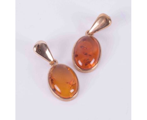 A pair of 9ct yellow gold drop earrings set with oval cabochon cut amber by the Scottish designer Sheila Fleet, with post and