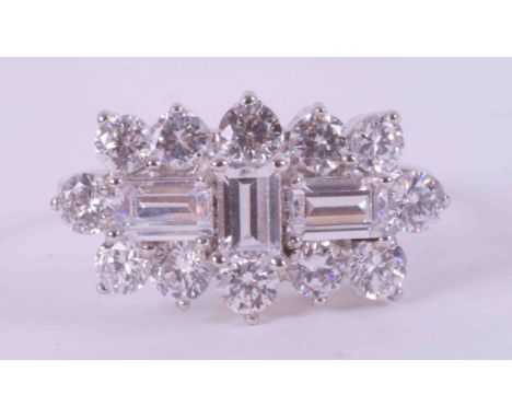 A 9ct white gold cluster style ring set with a mixture of round cut &amp; emerald cut crystals, 3.88g, size R.