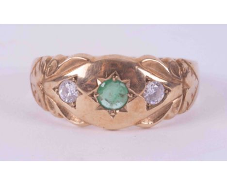 A 9ct yellow gold gypsy style ring set with a central emerald, approx. 0.17 carats and two white paste stones, 2.41g, size M 