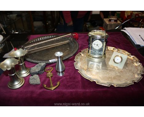 A quantity of Epns including two circular trays, candle holders, two small clocks, glass rolling pin, etc.