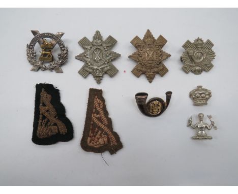 Selection of Various Scottish Badges cap badges include silvered and gilt Gordon Highlanders ... Silvered and gilt HLI bugle 