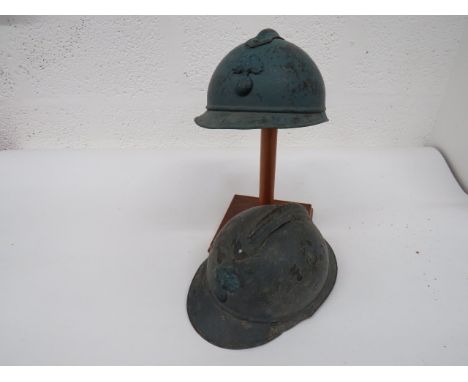 Two WW1 French 'Adrian' Pattern Steel Helmets blue painted crowns.  Attached front peak and rear brim with side seams.  Top c