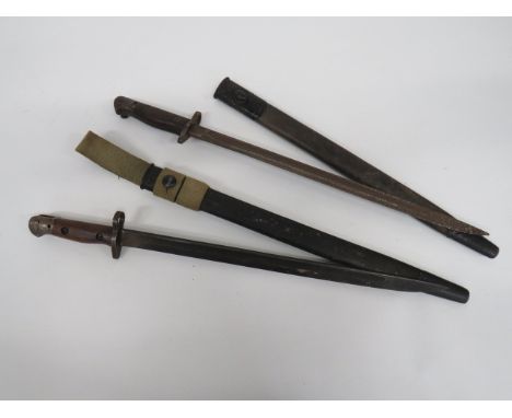 Two British SMLE Bayonets single edged blade with fuller.  Steel crossguard, muzzle ring and pommel.  Wooden slab grips.  Bot
