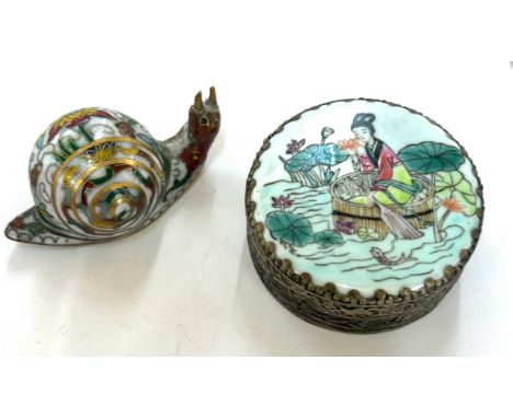 Small oriental metal snail and a mirrored trinket 