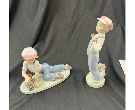 Lladro boy with train, Lladro boy with harmonica both in good overall condition 