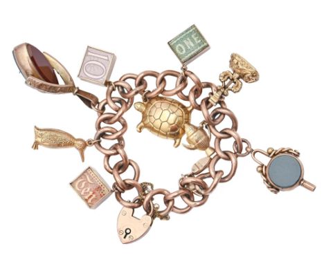 A gold charm bracelet with a collection of gold charms and 9ct padlock 18cm long 48.2g  Light wear and the odd minor dent