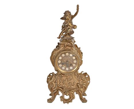 A Louis XV style brass mantle clock, mounted with a cherub, the dial with enamel chapters, 42cm h, key  