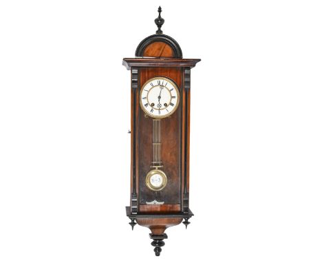 A walnut and ebonised Vienna wall clock,&nbsp;with gilt metal mounted enamelled dial and chapter ring, pendulum and key, circ