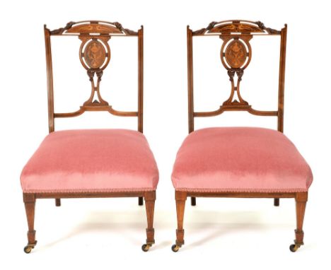 A pair of late Victorian rosewood and marquetry salon chairs, c. 1900, tapering square fore-legs, ceramic castors, seat heigh
