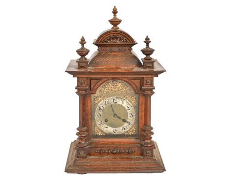 A German carved walnut&nbsp; bracket clock, early 20th c, brass dial with silvered chapter ring, 46cm h excluding finial, pen