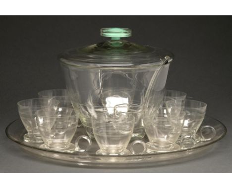 A glass punch set, mid 20th c, comprising punch bowl and cover, ladle, eight cups and tray, tray 44cm diam  Ladle handle chip