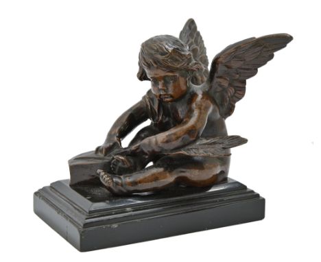 A French bronze figurine of a seated Putto sharpening an arrow, early 20th c, on slate base, 10cm h  Minor chips to base, oth
