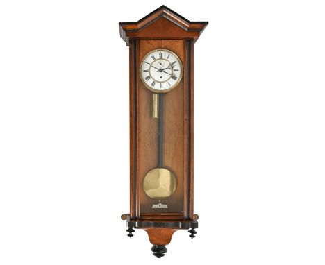A walnut and ebonised Vienna wall clock with gilt metal mounted enamel dial and chapter ring, weight, pendulum and key, circa