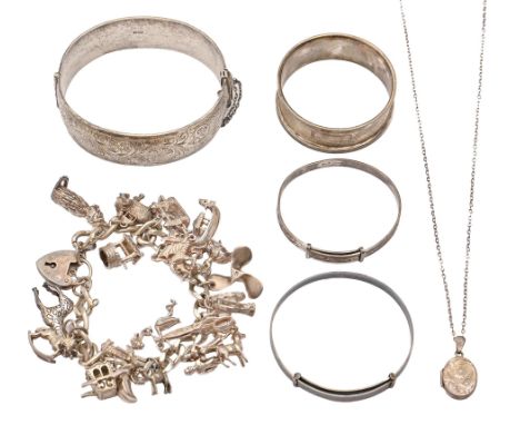 A silver charm bracelet, two other silver bracelets and a bangle, a pendant and silver napkin ring, 4oz 18dwt (6)  