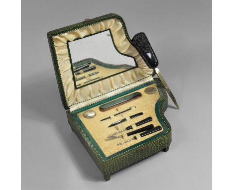 A Vintage Novelty Manicure Set, in Faux Crocodile Skin Mounted Box in the Form of a Grand Piano with Musical Movement Togethe