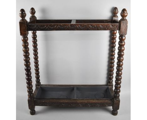 An Edwardian Oak Rectangular Stick Stand with Bobbin Supports and Acorn Finials, 61cms Wide and 23cms Deep with Metal Drip Tr