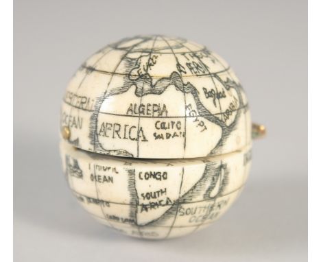 AN ETCHED BONE FOLDING GLOBE COMPASS. 1.5ins diameter.