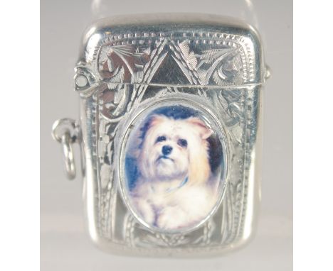 AN EDWARD VII SILVER VESTA CASE with an oval enamel of a Scottie dog. 1.5ins x.75ins Birmingham 1907.