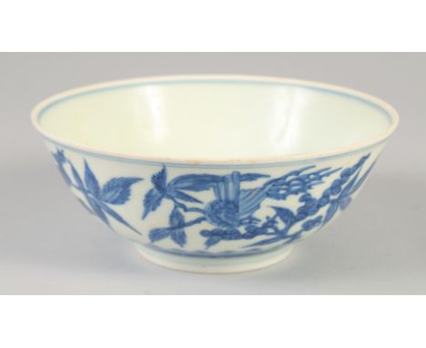 A CHINESE BLUE AND WHITE PORCELAIN BOWL with floral decoration and birds, six character mark to base. 19cm diameter.