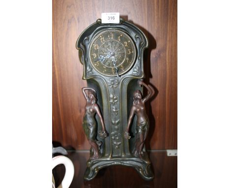 AN ART NOUVEAU STYLE FIGURATIVE RESIN CLOCK 