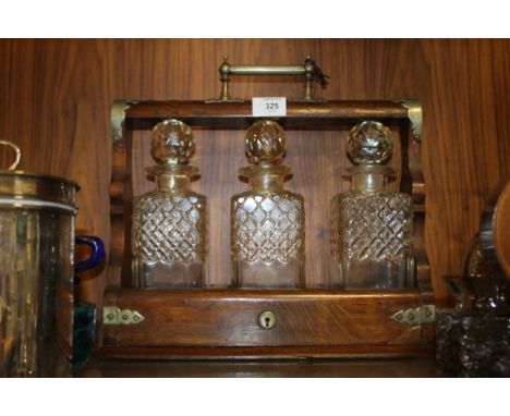 A VINTAGE THREE DECANTER OAK TANTALUS 