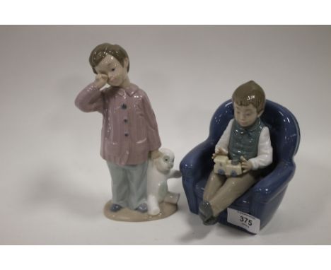 A NAO SEATED BOY FIGURE TOGETHER WITH A NAO BOY WITH TEDDY BEAR (2)