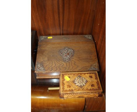 AN ART NOUVEAU STYLE OAK WRITING SLOPE WITH COPPER DETAILING TOGETHER WITH A CARVED TRINKET BOX (2) 