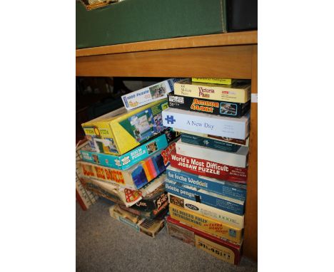 A LARGE QUANTITY OF VINTAGE JIGSAWS AND BOARD GAMES