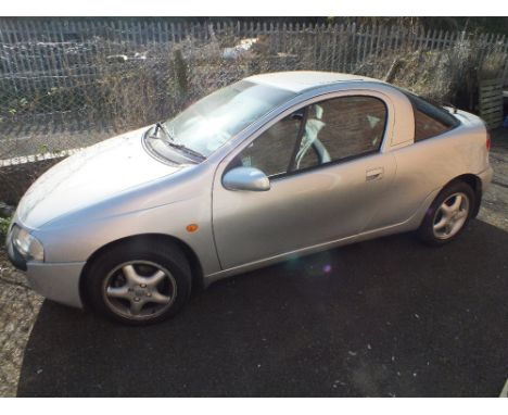 A SILVER VAUXHALL TIGRA COUPE WITH KEYS AND LOG BOOK