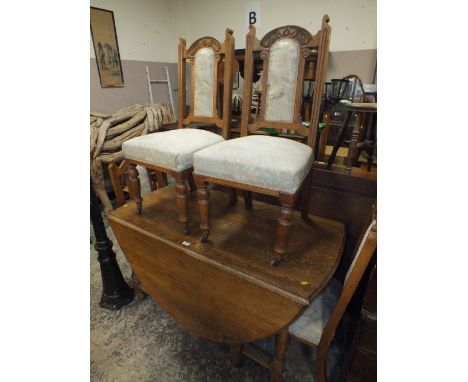 A LARGE OAK DROPLEAF DINING TABLE TOGETHER WITH FOUR ART NOUVEAU CHAIRS