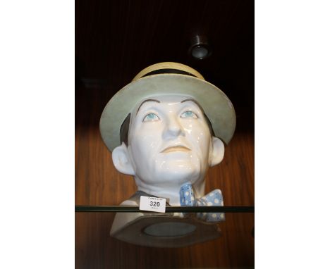 AN UNUSUAL CERAMIC BUST OF A GENTLEMAN IN HAT AND BOW TIE 