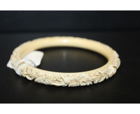 AN ANTIQUE CARVED IVORY BANGLE, internal Dia. 8.1 cmConditon Report:Approx 38.8 g