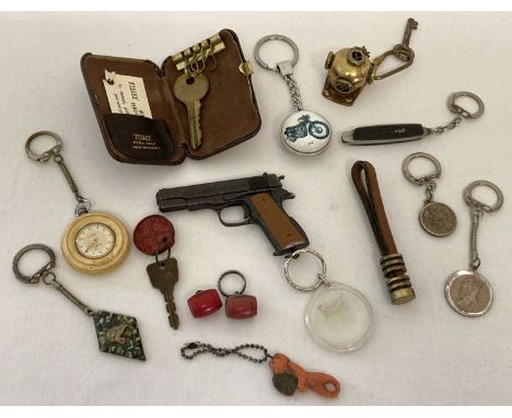 A collection of 13 vintage keyrings, to include advertising and novelty. Examples include: Watney's Red Barrel, Timex white t