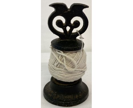 A black painted cast iron decorative string dispenser by Victor R Welch.  Approx. 14cm tall.