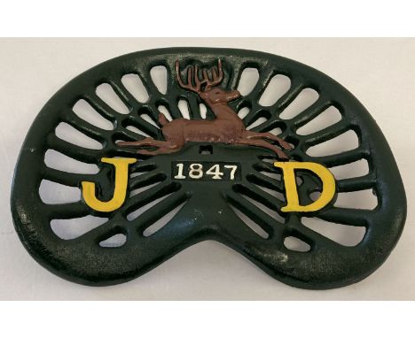 A painted cast metal tractor seat with John Deere logo.  Approx. 36cm x 42cm.
