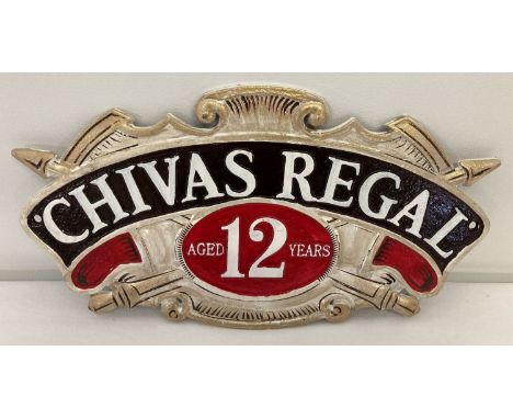 A Chivas Regal Scotch whisky painted cast metal wall hanging plaque. In gold, black, white and red and with fixing holes. App