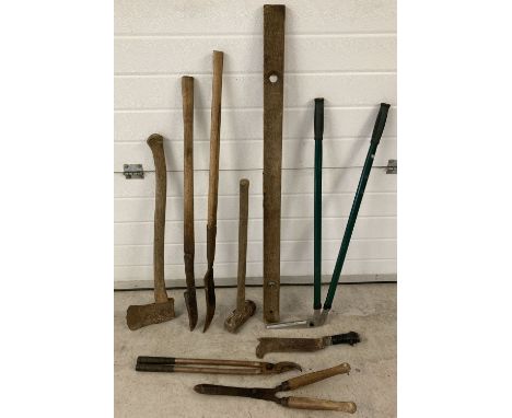 A collection of vintage gardening and maintenance tools. To include: axe, hedge slashers, sledge hammer and shears. 