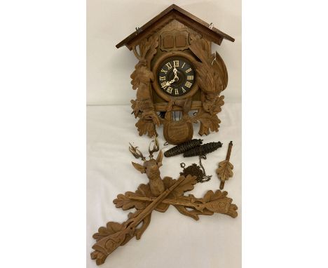A vintage German Black Forest style wooden cased cuckoo clock, complete with pendulum and weights. Removable top finial with 