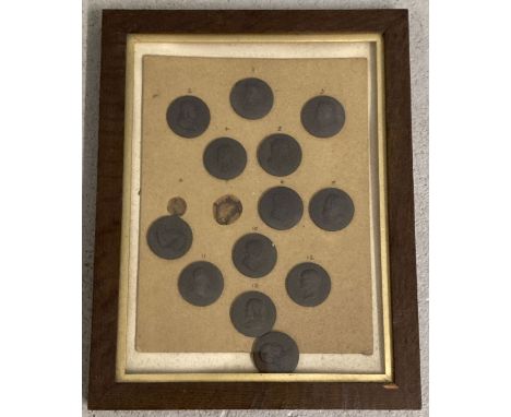 A framed and glazed collection of 13 miniature Wedgwood black basalt round portrait plaques. Each depicting a famous, artist,
