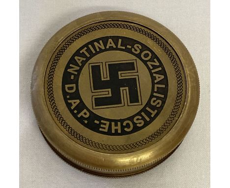 A reproduction brass cased German WWII style N.S.D.A.P compass with screw lid. Underside marked with German National Railway 